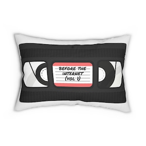 May include: A white pillow with a black and white image of a VHS cassette tape. The cassette tape has a red label that says "Before the Internet (Vol 1)".