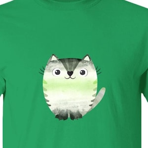 May include: A green t-shirt with a cartoon illustration of a gray and white cat with green stripes. The cat is smiling and has a green and white striped tail.
