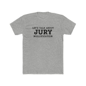 May include: A heather gray t-shirt with black text that reads "Let's talk about Jury Nullification".