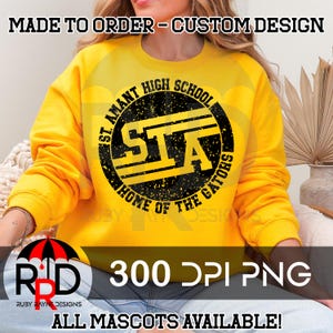 May include: A yellow sweatshirt with a black and yellow circle graphic that says "St. Amant High School STA Home of the Gators". The graphic has a distressed look. The text "300 DPI PNG" is below the graphic. The text "All Mascots Available!" is below the text "300 DPI PNG".