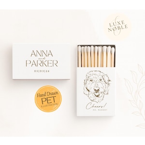 White wedding matchboxes with Light AI enhanced hand drawn dog illustration saying Cheers personalized with couple’s names and date by Luxe and Noble