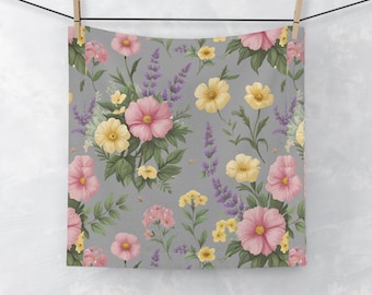 May include: A gray floral pattern featuring pink, yellow, and purple flowers with green leaves. The design includes various flower types, such as cosmos, lavender, and daisies. The fabric is hanging from a clothesline.