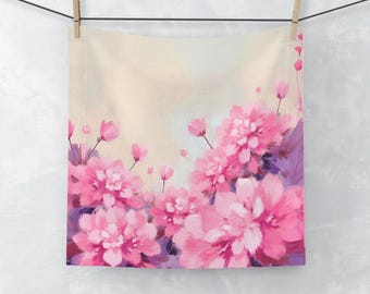 May include: A square, floral-themed fabric hanging from a clothesline. The design features large, vibrant pink peonies and smaller pink buds against a soft, light background. Purple leaves and stems add depth to the floral arrangement.