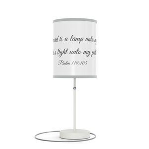 May include: White table lamp with a gray lampshade featuring the text "Thy word is a lamp unto my feet and a light unto my path. Psalm 119:105".