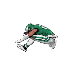 May include: A football player wearing a green and white uniform dives to catch the ball. The player is wearing a helmet and has a determined expression on their face.