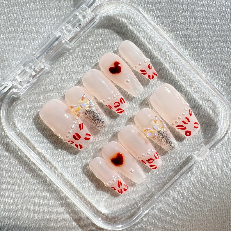 Hugs and kisses press on nails. With pearls and bow, little love heart. Such an adorable set.