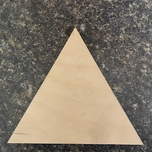 May include: A plain, light brown wooden triangle.