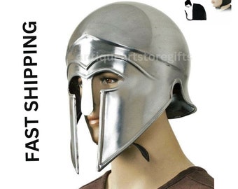May include: A silver Spartan helmet with a face mask and a chin strap. The helmet is on a mannequin head. The text "FREE COTTON CAP" is at the top of the image.
