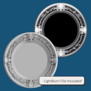 May include: Two white ornate round frames with a decorative design. The frame on the left is a 3D model with a white background. The frame on the right is a 2D image with a black background. The text "LightBurn File Included!" is at the bottom of the image.