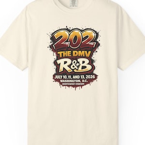 May include: A cream-colored short-sleeve t-shirt featuring a graphic with the text 202 THE DMV R&B JULY 10, 11, AND 13, 2026 WASHINGTON, D.C. NORTHWEST STADIUM in a stylized, graffiti-inspired font with red, yellow, and black paint splatter.