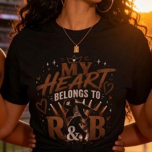 May include: A black t-shirt featuring the text MY HEART BELONGS TO R&B in brown and white lettering, accompanied by a graphic of a person dancing under spotlights, small heart icons, and stars, with the shirt tied in a knot at the front hem.
