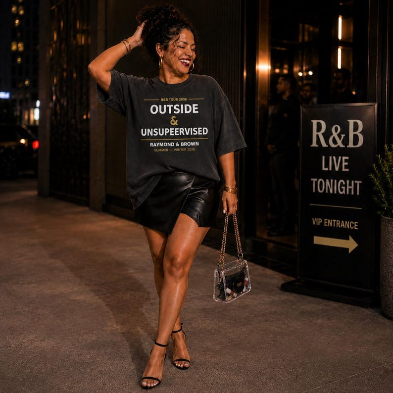 May include: A woman wearing a dark gray oversized t-shirt with the text "OUTSIDE & UNSUPEERVISED" and a black leather skirt. She is holding a clear purse with a gold chain strap and wearing black high-heeled sandals. A sign for an R&B live show is in the background.
