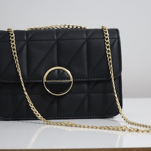 Black leather quilted crossbody with gold chain