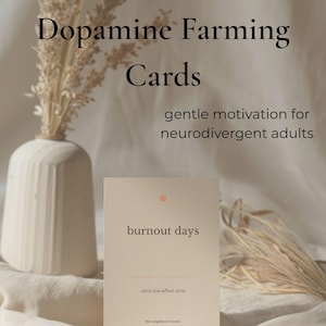 May include: A beige card with the words "burnout days" and "ultra-low effort wins" is displayed. The card is part of a set called "Dopamine Farming Cards" with the tagline "gentle motivation for neurodivergent adults."