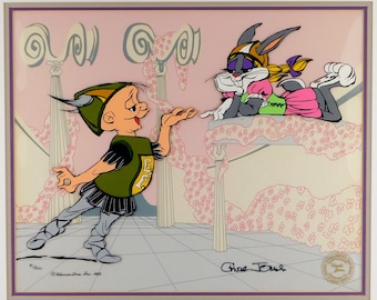 May include: A framed animation cel featuring cartoon characters. A male character in a green and black outfit gestures towards a female rabbit character in a pink and green dress. The background is a pink and white floral design.