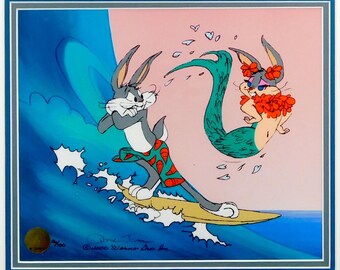 May include: A framed cartoon print depicting Bugs Bunny surfing on a yellow surfboard, with Lola Bunny as a mermaid. Bugs Bunny is wearing red and green swim shorts. The background shows a blue wave and a pink sky. The print is signed and numbered.