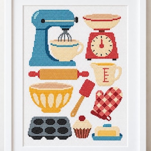May include: A framed cross-stitch pattern featuring various kitchen tools and baking items including a blue stand mixer, a red kitchen scale, a yellow mixing bowl, a rolling pin, a measuring pitcher, a red spatula, a red checkered oven mitt, a muffin tin, a cupcake, and a butter dish.