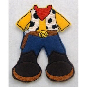May include: A felt applique of a cowboy outfit. The outfit is yellow, blue, brown, and red. The cowboy is wearing a waistcoat with white polka dots, a red bandana, blue jeans, and brown boots.