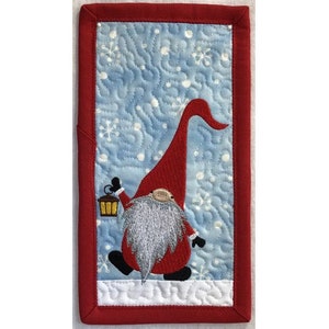 May include: A red and white gnome with a long, pointed hat and a lantern in its hand stands on a blue and white background with snowflakes.