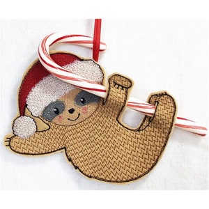 May include: A brown sloth wearing a red Santa hat with a white pom-pom, holding a red and white candy cane.