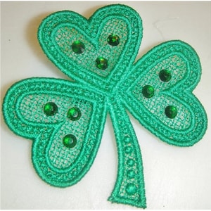 May include: Green felt shamrock with green glitter embellishments. The shamrock is a traditional Irish symbol.