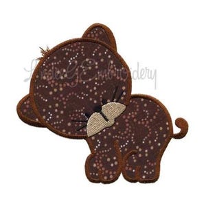 May include: Brown and tan embroidered applique of a cartoon cat with a spotted pattern. The cat is facing to the left and has a small tail.