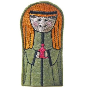May include: A green felt finger puppet of a girl with long orange hair wearing a green robe and holding a red heart.