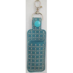 May include: Teal blue leather keychain with a silver metal clasp and a turquoise button. The keychain has a stitched pattern.
