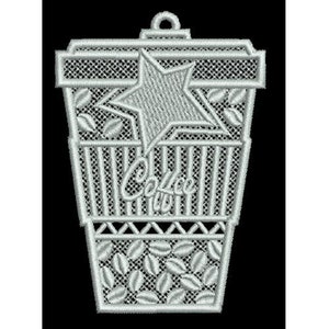 May include: A silver-colored embroidery design of a coffee cup with a star and coffee beans. The design is intricate and detailed, with a delicate lace-like pattern.