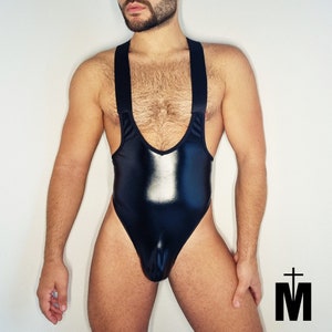 Pode incluir: Um body preto brilhante sem mangas com decote redondo e alças. O body tem um corte de perna alto e um design justo.