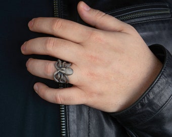 May include: A silver octopus ring with detailed tentacles.