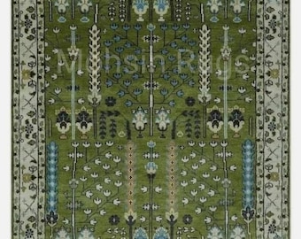 May include: A rectangular green rug with a detailed floral pattern. The rug features a central design of stylized trees and floral motifs in shades of white, blue, and black. The border is a cream color with a repeating floral pattern.