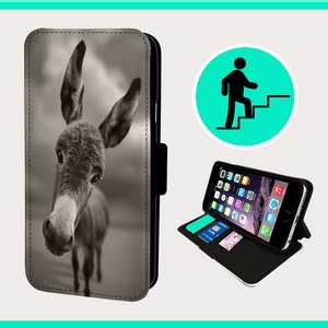May include: A black and white photograph of a donkey's head and neck. The donkey is looking directly at the camera. The photo is printed on a black phone case with a flap.