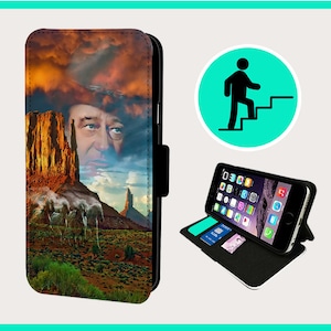 May include: A black leather phone case with a colorful image of a man's face and a desert landscape. The case has a flap that folds over the phone screen.