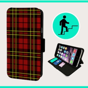 May include: A red, black, and yellow plaid phone case with a flap that closes with a snap. The case is designed to fit a smartphone and has a built-in stand.