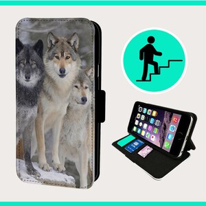 May include: A black leather phone case with a stand feature. The case has a printed image of three wolves in a snowy forest setting.