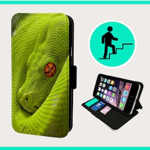 May include: A green snake with an orange eye is featured on a black phone case. The case has a flap that folds over the phone screen to protect it.