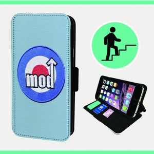 May include: A light blue phone case with a Mod target logo. The case is open, displaying a smartphone with apps visible on the screen. The case has a black interior with card slots. A green circle with a person climbing stairs is also shown.