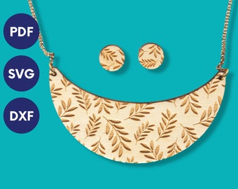 May include: A wooden necklace with a crescent moon shape and a leaf pattern. The necklace comes with a pair of matching earrings. The necklace and earrings are made of wood and have a natural wood finish.