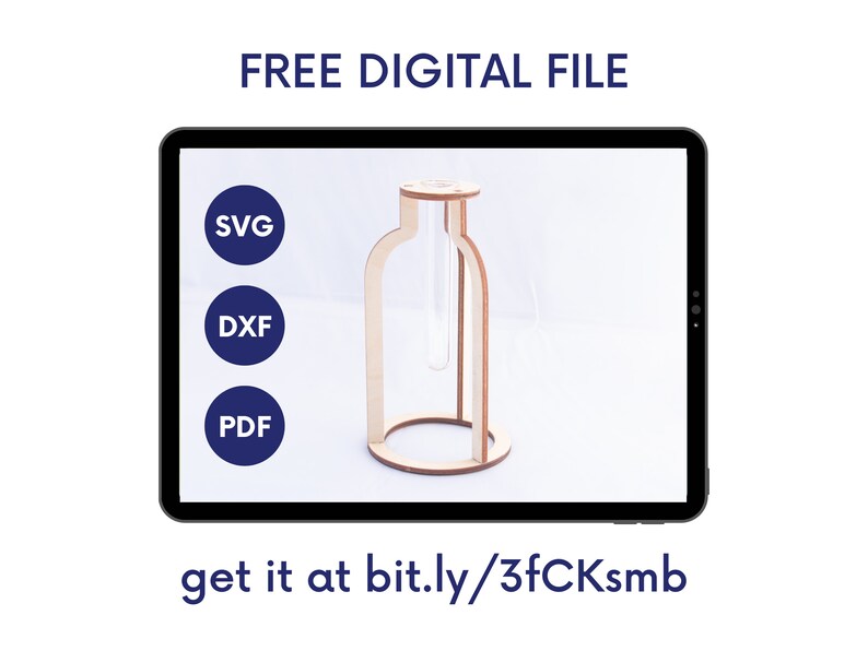 May include: A digital file download for a wooden vase with a glass test tube insert. The file is available in SVG, DXF, and PDF formats. The text on the screen reads "FREE DIGITAL FILE" and "get it at bit.ly/3fCKsmb".