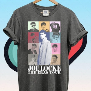 May include: A charcoal gray short-sleeve t-shirt featuring a collage of nine different photographs of Joe Locke in various poses and outfits. Below the collage, the text reads JOE LOCKE THE ERAS TOUR in white capital letters. The shirt has a crew neck.