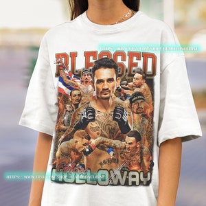 a woman wearing a white t - shirt with a photo of a wrestler on it