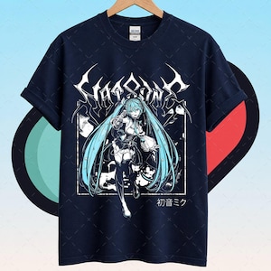 May include: Navy blue t-shirt featuring a white and light blue anime graphic. The graphic includes the text "Chaosain" in a stylized font, along with an anime character with long blue hair. Japanese text is also present.