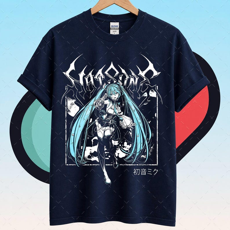 May include: Navy blue t-shirt featuring a white and light blue anime graphic. The graphic includes the text "Chaosain" in a stylized font, along with an anime character with long blue hair. Japanese text is also present.