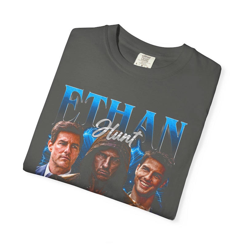 Vintage washed pepper Comfort Colors graphic tee featuring Ethan Hunt action spy hero portrait collage, retro secret agent-inspired design, unisex oversized streetwear shirt, cinematic adventure fandom t-shirt.