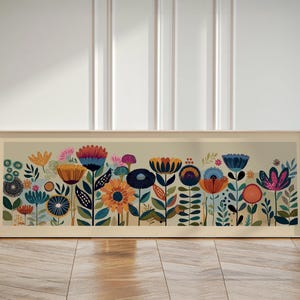 May include: A framed floral art print featuring a colorful array of stylized flowers in shades of orange, blue, pink, and yellow. The artwork is set against a light beige background and framed in a light wood tone.