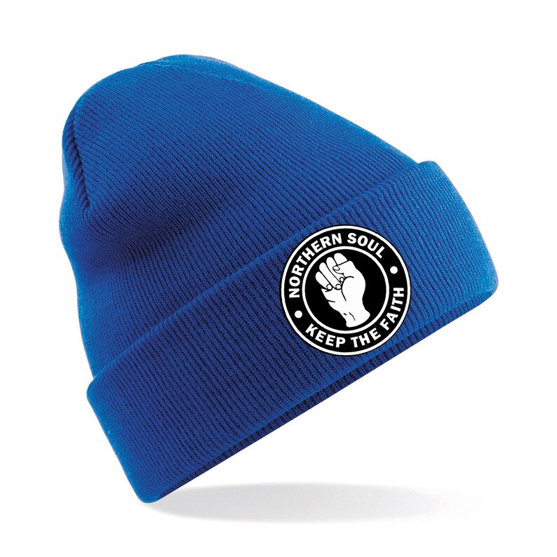 May include: A royal blue beanie with a white circle patch that says "Northern Soul Keep The Faith" with a raised fist in the center.