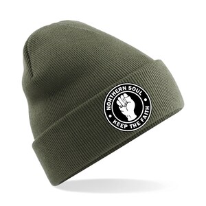 May include: A green beanie with a white circle logo that says "Northern Soul Keep The Faith" with a raised fist in the center.