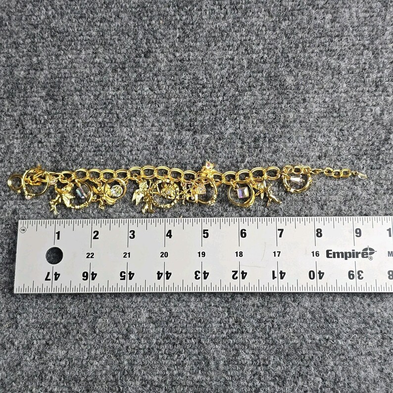 Pulsera con dije "El secreto de los siete ángeles" de Kirks Folly, estilo vintage, en caja. imagen 8