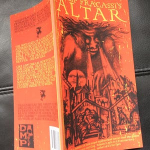 May include: A paperback book titled "Philip Fracassi's Altar" with a red cover featuring a monster illustration. The book's spine is visible, displaying text and a publisher's logo. The cover art depicts a nightmarish scene.